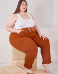 Marielena is wearing Rolled Cuff Sweat Pants in Burnt Terracotta and Cropped Tank in vintage tee off-white