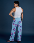 Back view of Floral Painted Work Pants in Blue and Cropped Tank in Vintage Tee White on Jesse