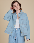 Hana is 5'3" and wearing P Indigo Denim Work Jacket in Light Wash