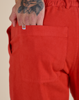 Close up of Jesse's hand in the back pocket of Work Pants in Mustang Red