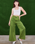 Alex is wearing Overdyed Wide Leg Trousers in Gross Green and Cropped Tank Top in vintage tee off-white 