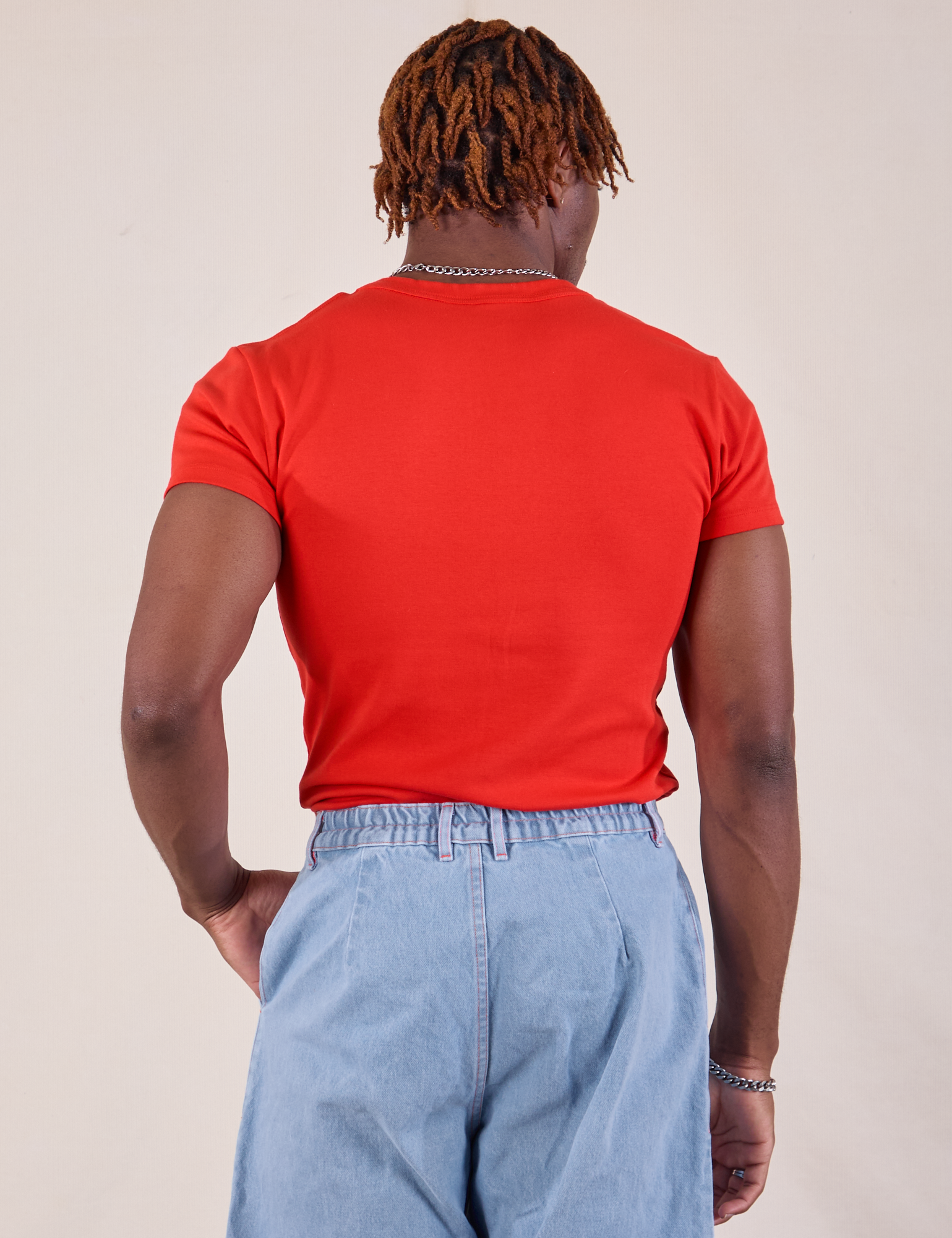 Baby Tee in Mustang Red back view on Isaac
