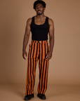 Isaac is 5’10 and wearing M Black Stripe Work Pants in Construction Orange paired with black tank top
