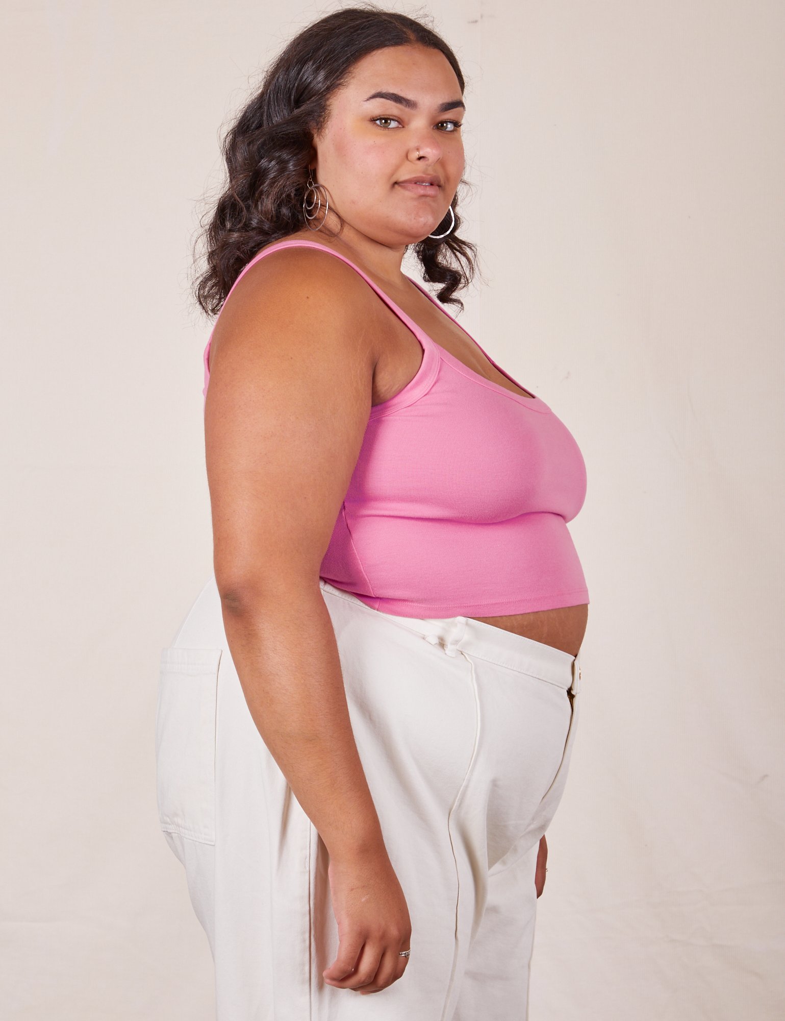 Side view of Cropped Cami in Bubblegum Pink and vintage off-white Western Pants worn by Alicia