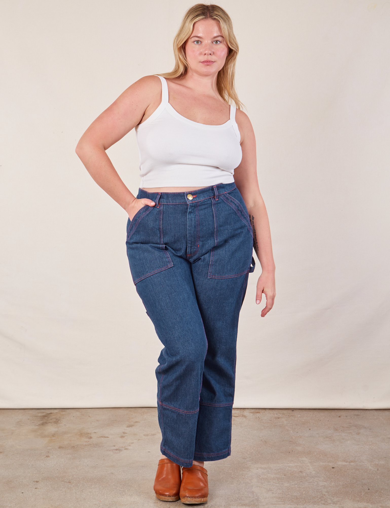 Lish is wearing Cropped Cami in Vintage Tee Off-White and dark wash Carpenter Jeans