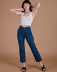 Alex is 5’8” and wearing XXS Carpenter Jeans in Dark Wash paired with a Cropped Tank in Vintage Tee White