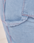 Carpenter Jeans in Light Wash close up of hammer loop. Red stitching on the pants.