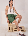 Anthony is wearing Easy Shorts in Dark Emerald Green and Tank Top in vintage tee off-white