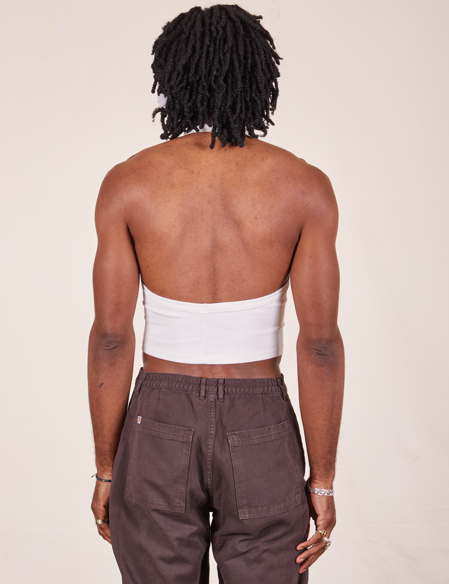Back view of Halter Top in Vintage Tee Off-White and espresso brown Western Pants worn by Jerrod