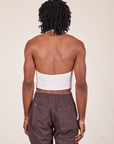 Back view of Halter Top in Vintage Tee Off-White and espresso brown Western Pants worn by Jerrod
