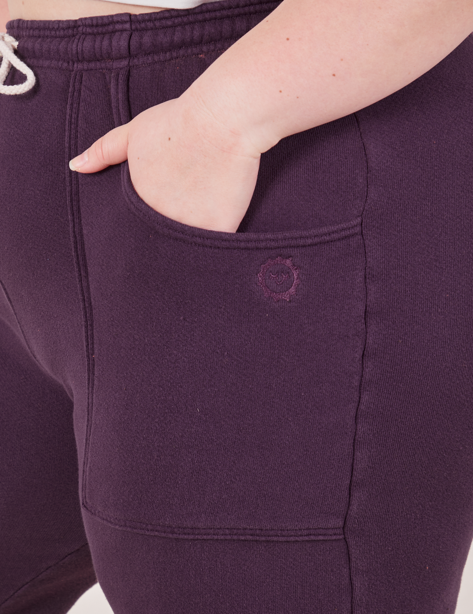 Rolled Cuff Sweat Pants in Nebula Purple front pocket close up. Ashley has her hand in the pocket.