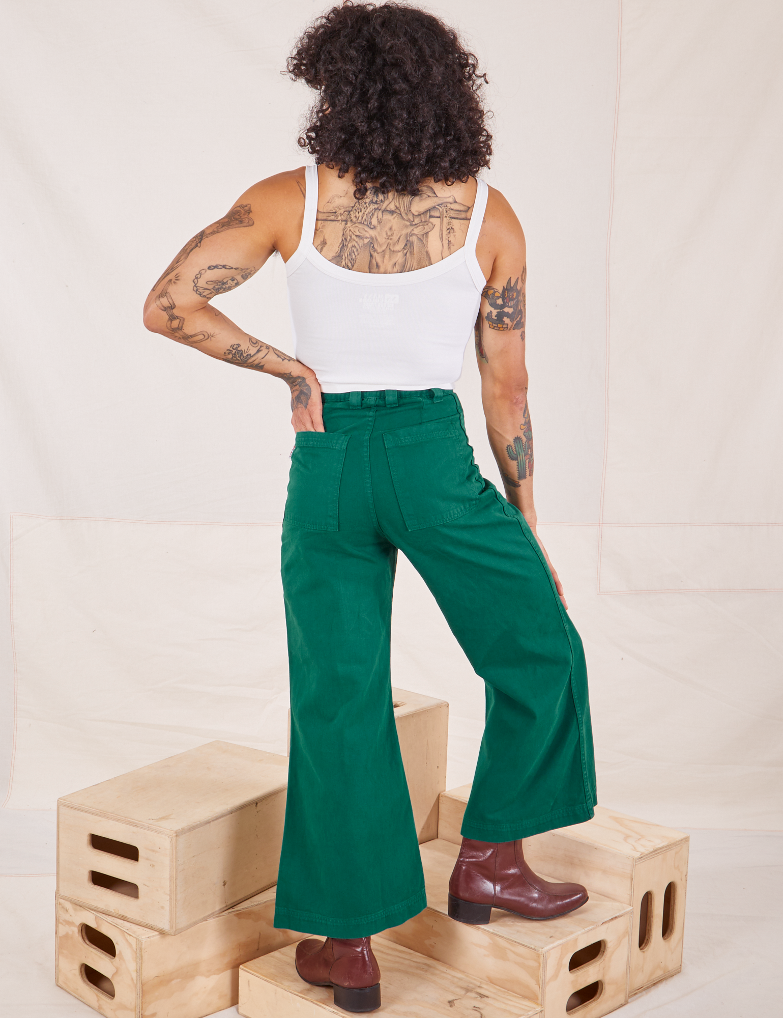Back view of Bell Bottoms in Hunter Green and Cropped Cami in vintage tee off-white worn by Jesse