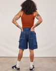 Back view of Carpenter Shorts in Dark Wash and burnt terracotta Cropped Tank on Jesse