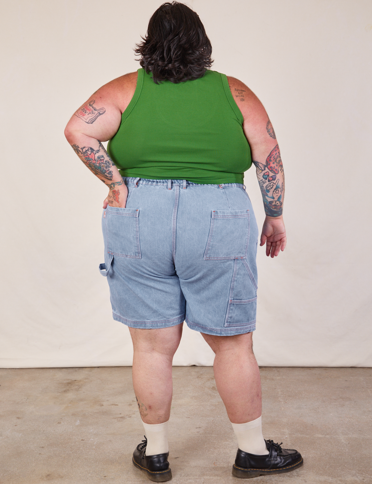Back view of Carpenter Shorts in Light Wash and lawn green Cropped Tank on Sam