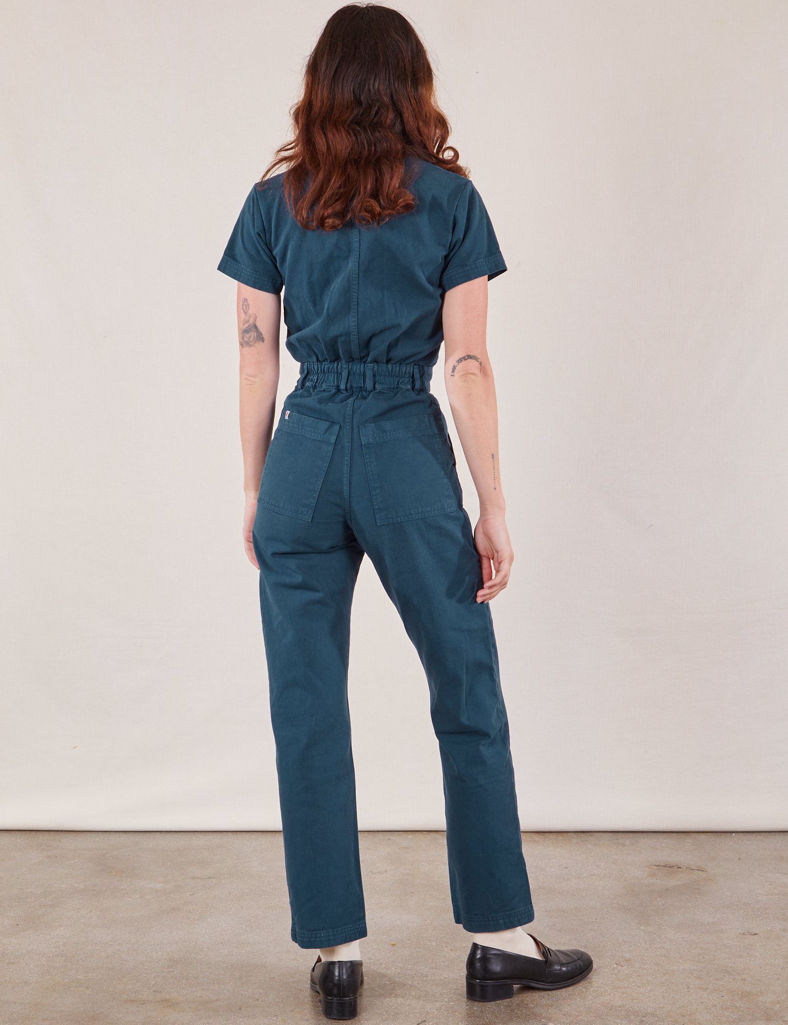 Short Sleeve Jumpsuit in Lagoon back view on Alex