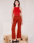 Alex is wearing Racerback Tank in Mustang Red and paprika Western Pants