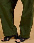 Baggy Mid-Rise Trousers in Evergreen pant leg close up on Alex