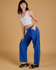Side view of Baggy Mid-Rise Trousers in Royal Blue and vintage tee white Cropped Tank on Alex
