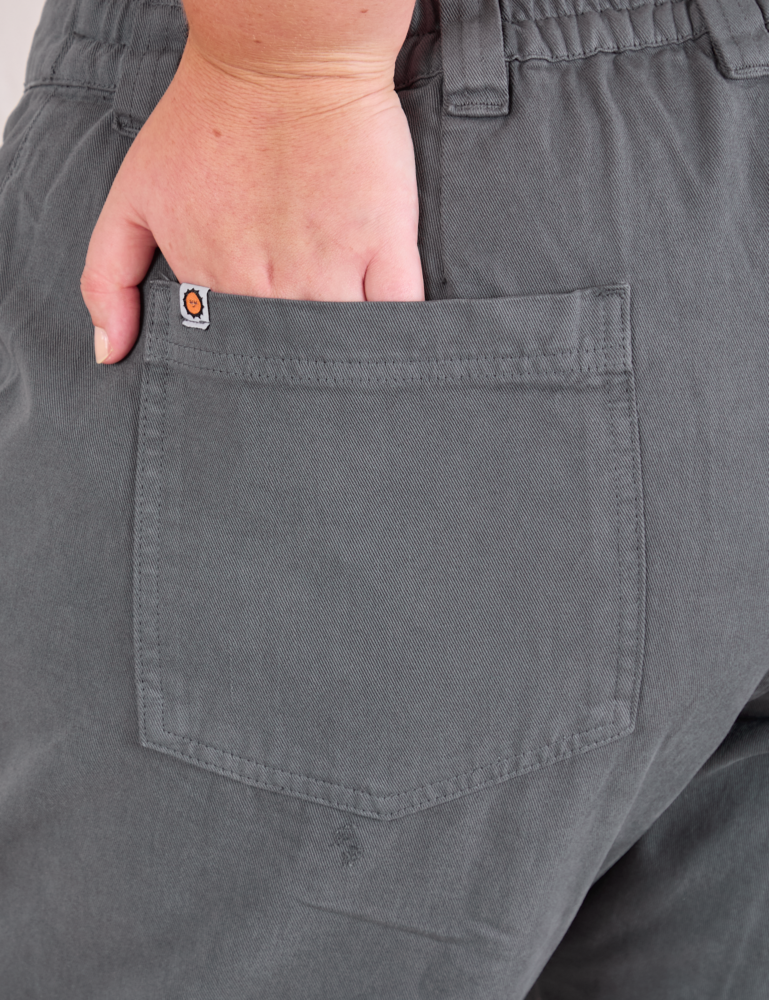 Mid-Rise Work Pants in Slate Grey close up of Juliet's hand in the back pocket