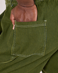 Close up of Elijah's hand on the back pocket of Railroad Carpenter Jeans in Summer Olive