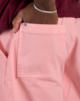 Close up of Isaac's hand in the back pocket of Longline Work Shorts in Baby Pink