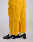 Drop Pocket Cargo Pants in Sunshine Yellow pant leg close up on Kira