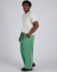 Side view of Drop Pocket Cargo Pants in Seafoam Green and Organic Vintage Tee in Vintage Tee White on Isaac
