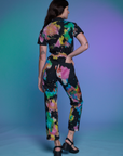 Short Sleeve Jumpsuit in Rainbow Magic Waters back view on Alex