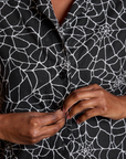 Close up of Kandia buttoning the Spider Webs Pantry Top