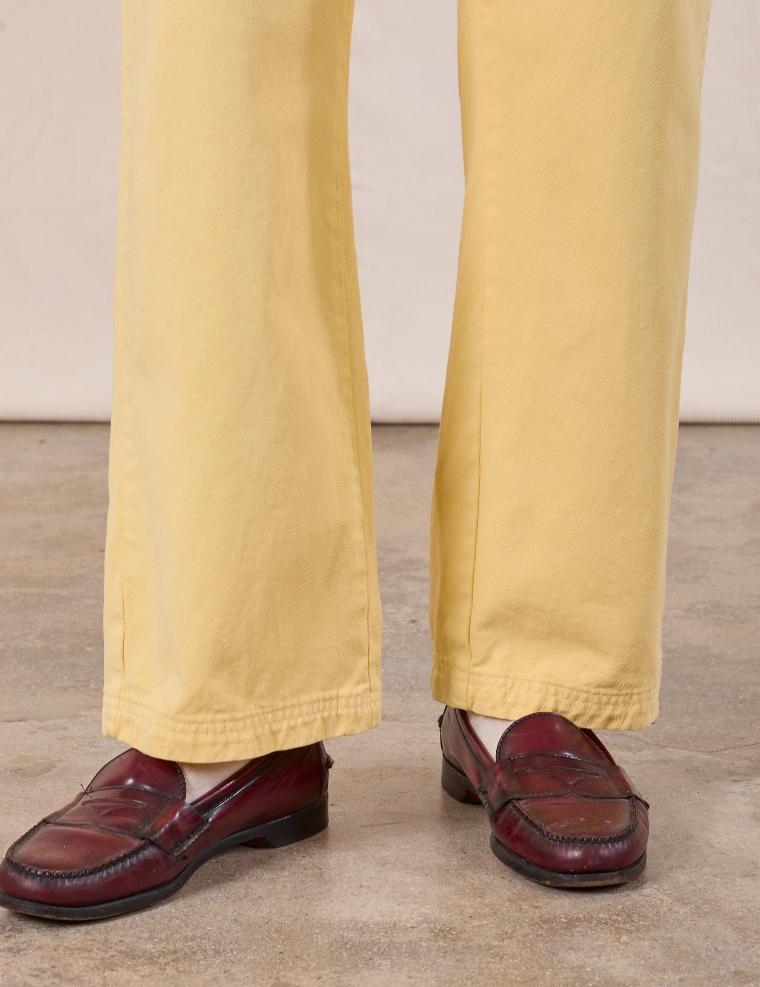 Work Pants in Butter Yellow pant leg close up on Anthony