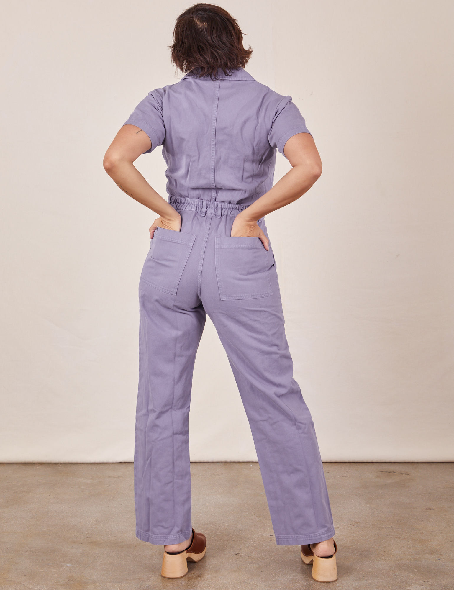 Back view of Short Sleeve Jumpsuit in Faded Grape worn by Tiara