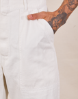 Front pocket close up of Short Sleeve Jumpsuit in Vintage Tee Off-White. Jesse has their hand in the pocket.