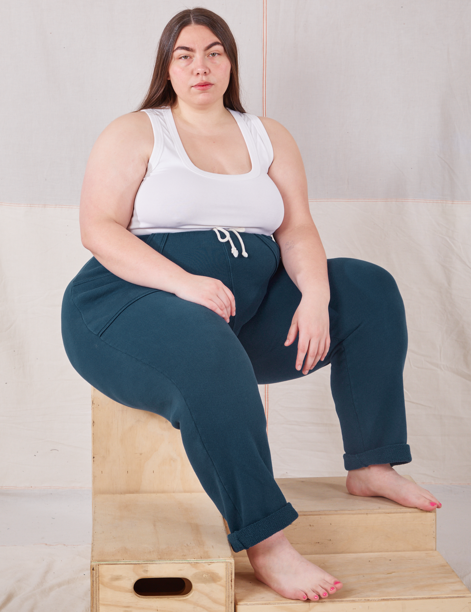 Marielena is wearing Rolled Cuff Sweat Pants in Lagoon and vintage off-white Cropped Tank