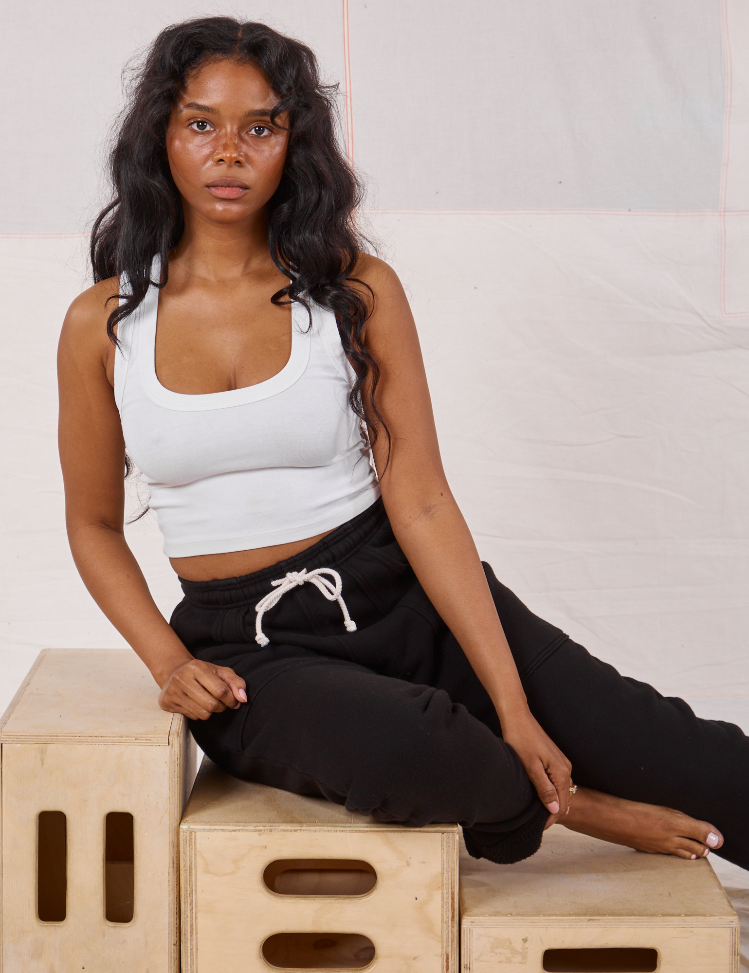 Kandia is wearing Rolled Cuff Sweat Pants in Basic Black and Cropped Tank in vintage tee off-white