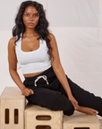 Kandia is wearing Rolled Cuff Sweat Pants in Basic Black and Cropped Tank in vintage tee off-white