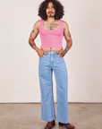 Jesse is wearing Cropped Tank Top in Bubblegum Pink paired with light wash Sailor Jeans
