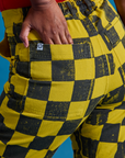 Close up of Kandia's hand in the back pocket of Checkerboard Work Pants in Yellow/Black