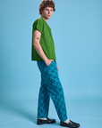 Side view of Checkerboard Work Pants in Blues and lawn green Organic Vintage Tee on Quinn