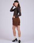 Pleated Trouser Shorts in Fudgesicle Brown angled back view on Alex