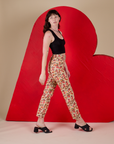 Side view of Work Pants in Hot Stuff Print and black Cropped Tank on Alex