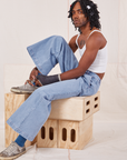 Jerrod is wearing Indigo Wide Leg Trousers in Light Wash and vintage off-white Cami