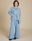 Hana is wearing Indigo Denim Work Jacket in Light Wash and light wash Indigo Wide Leg Trousers