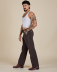 Side view of Work Pants in Espresso Brown and vintage tee white Cropped Tank on Jesse