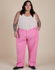 Sam is 5’10” and wearing 4XL Work Pants in Bubblegum Pink paired with a Cropped Tank in Vintage Tee White