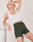 Madeline is wearing Classic Work Shorts in Swamp Green and Cropped Tank Top in vintage tee off-white
