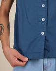 Bottom close up of Pantry Button-Up in French Blue with Anthony holding the hem