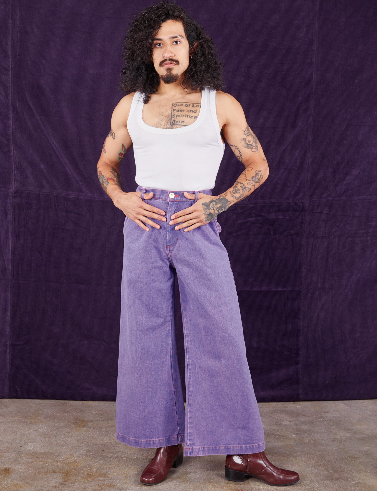 Jesse is wearing Overdyed Wide Leg Trousers in Faded Grape and Cropped Tank Top in vintage tee off-white