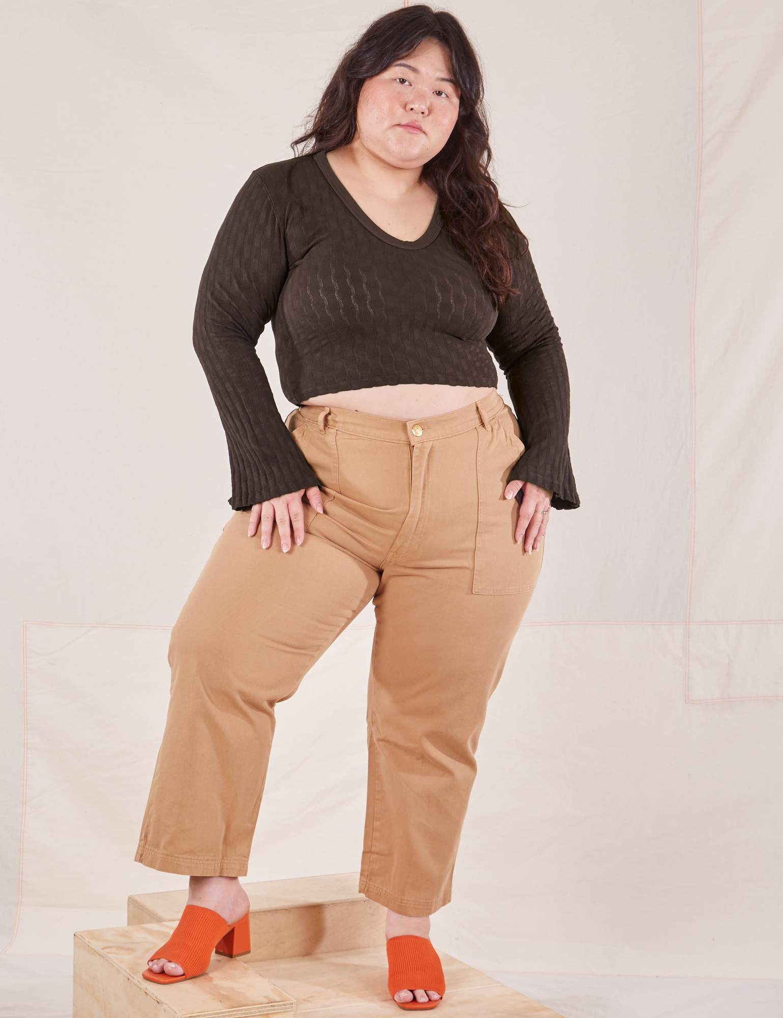 Ashley is wearing Bell Sleeve Top in Espresso Brown and tan Work Pants