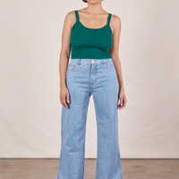 Tiara is wearing Cropped Cami in Hunter Green and light wash Sailor Jeans