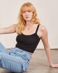 Margaret is wearing Cropped Cami in Basic Black and light wash Carpenter Jeans